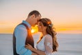 Unusual wedding photo shoot in the desert. Background white sands at sunset. Happy brunette girl with long hair and a Royalty Free Stock Photo