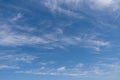 Unusual white striped wavy clouds in a bright blue sky. Heavenly background for your photos. Perfect Sky photo Royalty Free Stock Photo