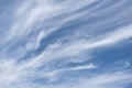 Unusual white striped wavy clouds in a bright blue sky. Heavenly background for your photos. Perfect Sky photo Royalty Free Stock Photo