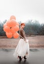 Unusual woman with balloons as concept outdoors