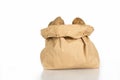 Unwashed potatoes in a paper bag islated on white