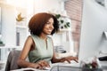 Unwavering in her productivity. a young businesswoman working at her desk in a modern office.