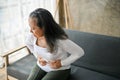 Unwell Asian senior woman suffering from stomachache, food poisoning, gastritis Royalty Free Stock Photo