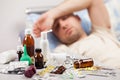 Unwell man patient lying down bed Royalty Free Stock Photo