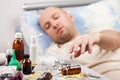 Unwell man patient lying down bed Royalty Free Stock Photo