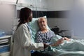 Unwell senior patient laying in bed breathing through oxygen test tube