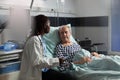 Unwell senior patient laying in bed breathing through oxygen test tube