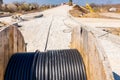 Unwinding cable of spool, coil at construction site Royalty Free Stock Photo