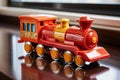 unwrapped toy train from a glossy gift box