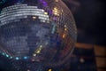 Up close glittery disco ball with a dark background