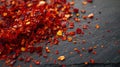 An up close image of vibrant red chili flakes sprinkled on a dark surface, creating . Generative Ai