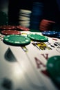 Up close photograph of playing cards and stacks of poker chips Royalty Free Stock Photo