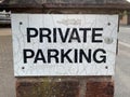 Up close picture of a old weathered private parking sign