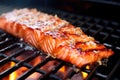 up close, salmon fillet with apple cider glaze sizzling on a bbq grill