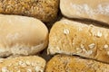 Up close shot of six wholegrain and white seeded bread rolls