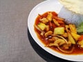 Up close a sweet sour chicken sauce mixed with white rice for lunch hour meal