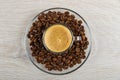 ÃÂ¡up with coffee espresso in saucer with coffee beans on table. Top view Royalty Free Stock Photo