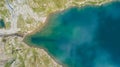 Up and down drone aerial view of the Lake Barbellino a natural alpine lake in the summer. Snow is melting