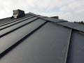 close up view of grey folding roof and chimney on waterproofing layer of house under construction Royalty Free Stock Photo