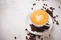 A up of hot latte coffee with roasted coffee beans Royalty Free Stock Photo