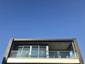 Balcony of a stylish building, blue sky background.