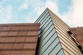 Up view on modern business office building and sky on the background. Urban exterior and tall perspective. Royalty Free Stock Photo