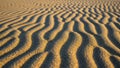 Up view of a sandy surface with wind formed ripple patterns showcasing Royalty Free Stock Photo