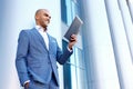 Upbeat businessman standing near column Royalty Free Stock Photo