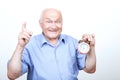 Upbeat grandfather holding alarm clock