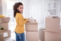 Cheerful girl smiling while unpacking her belongings Royalty Free Stock Photo