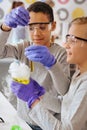 Upbeat schoolboys working on a chemical experiment together