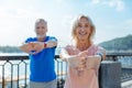 Upbeat senior couple working out in the streets