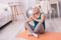 Upbeat senior woman posing while practicing yoga