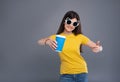 Upbeat teenage girl pointing at coffee cup