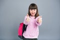 Upbeat teenage schoolgirl showing thumbs up