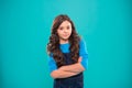 Upbringing confidence. Kid girl long hair posing confidently. Girl curly hairstyle feels confident. Child hold hands Royalty Free Stock Photo