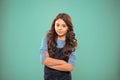 Upbringing confidence. Kid girl long hair posing confidently. Girl curly hairstyle feels confident. Child hold hands Royalty Free Stock Photo