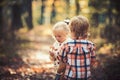 Upbringing and early development. Children harvest mushrooms in autumn forest. Little boy and girl friends camping in Royalty Free Stock Photo