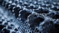 An upclose image of an aerographite panel highlighting its high density and impressive strength. The panel appears to be