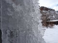 Upclose Shot of a Nubby Icey Wall with a Mountain in the Background