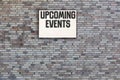 Upcoming Events message on Brick wall with light box