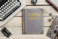 Upcoming Events on old book cover at office desk with vintage it Royalty Free Stock Photo