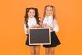 Upcoming events in school. Glad to inform. Schoolgirls informing you. School girls hold blank chalkboard copy space Royalty Free Stock Photo