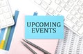 UPCOMING EVENTS text on blue sticker on chart with calculator and keyboard,Business concept Royalty Free Stock Photo