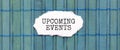 UPCOMING EVENTS text on the piece of paper on the green wood background Royalty Free Stock Photo