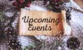 UPCOMING EVENTS text written on craft paper against the background of New Year\'s decor. View from above. Christmas or winter