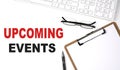 UPCOMING EVENTS text written on the white background with keyboard, paper sheet and pen Royalty Free Stock Photo