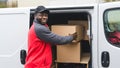 Upcoming holiday season sale via online shopping. Outdoor medium closeup shot of smiling surprised Black man in red-and Royalty Free Stock Photo