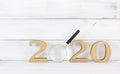 Upcoming 2020 New Year with Magnifying glass over white wood background, Search Goals Conccept Royalty Free Stock Photo