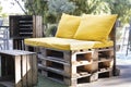 Upcycled outdoor seat made from pallets with wood crate as table Royalty Free Stock Photo